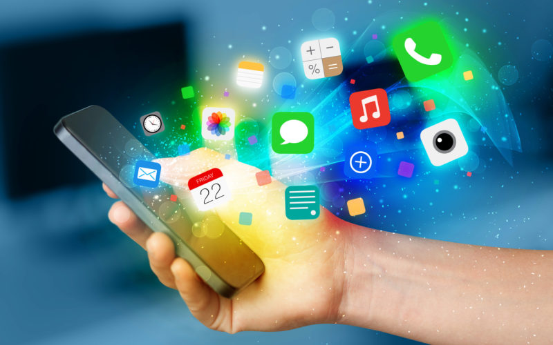 Hand holding smartphone with colorful app icons Hand holding smartphone with colorful app icons concept